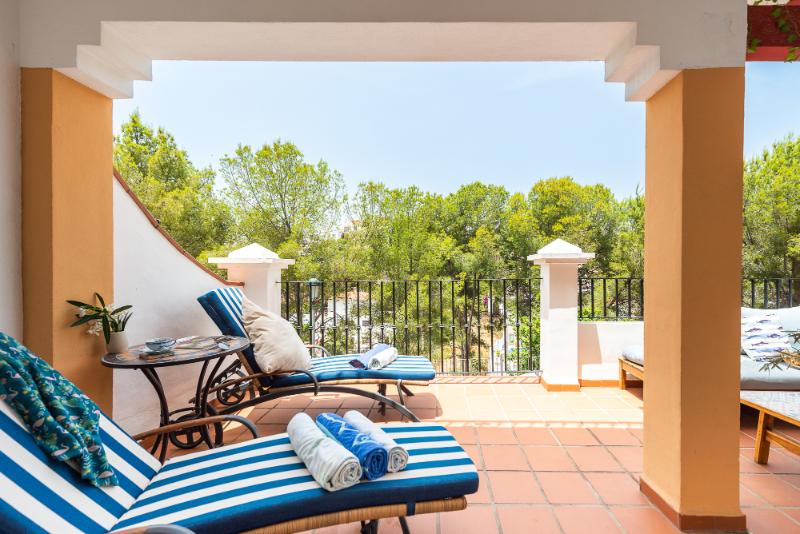 Sunny terrace with sunbeds